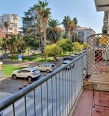 a balcony with a bench and a table with a chair