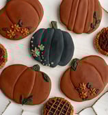 warm but dark themed fall cookies. pumpkins and flowers with rich dark colors