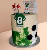 a cake with a soccer player and a soccer player