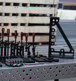a bunch of fixture tools on a welding table