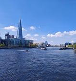 River Thames with boats and skyscrapers in background