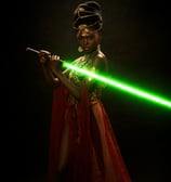 a black woman with green lightsaber