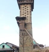 a tall tower with a clock on top of it