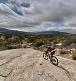 a person riding a bike on a rocky surface