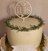 a cake with a wooden sign that says hhs