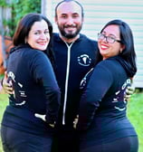 a man and woman in matching black outfits