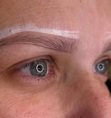 Woman after getting her eyebrows mapped by microblading master, ready for the procedure