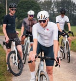 a group of men riding bikes on a path