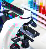 in a laboratory with microscope and sample tubes