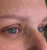 A woman with her current state of eyebrows before getting microblading procedure