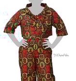 a woman in a red and green patterned blouse and pants