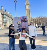 Soaked band holding Talk About It poster in front of Big ben