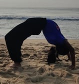a person doing a handstand on a beach