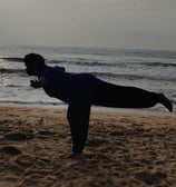 a person doing yoga on a beach
