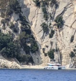 a boat on the water near a mountain