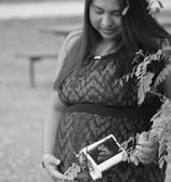 a pregnant woman in a lace dress and a flower crown