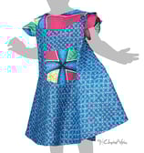 a little girl in a blue dress with a bow tie