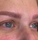 Woman after microblading was done showcasing her natural looking eyebrows