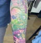 a man with a tattoo on his arm color fish and octopus