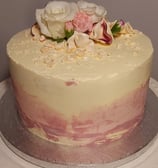 a cake with flowers on top of a white plate