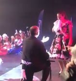 a man in a costume on stage