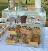 many assorted delicious baked goods in a case baked fresh daily