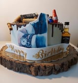 a birthday cake with a cake on top of a wooden table