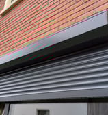 a window with a roller shuttered door and a window with a window