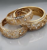 a close up of a bracelet on a pillow
