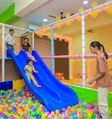 Kids sliding in the ball pool