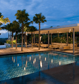 A pool side Hotel exterior patio space to unwind designed mindfully, showcased by shark hotels india