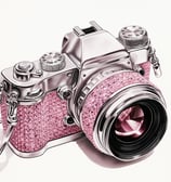 a pink camera with a pink strap and a silver strap