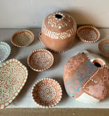 Pottery dishes and bird houses ready to glaze