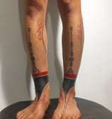 An handpoke tattoo featuring mentawai art tribal tattoo inspired, tattoo on legs