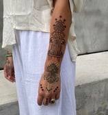 An handpoke tattoo featuring art ornaments hand weaving patterns NTB inspired, tattoo on sleeve