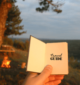 a person holding a book with a bookmark on it