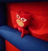 a stuffed animal toy sitting on top of a bouncer