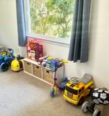 an organized playroom with ride on toys