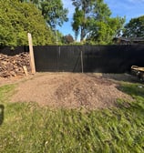 Professional stump removal using a grinder on a residential property in West Island