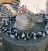 wedding cake on a table on the beach