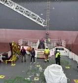 a large ship with a crane on the deck