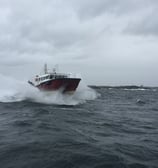 a boat in the ocean with a boat in the water