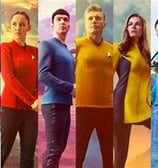 eight people standing next to one another from Star Trek crew