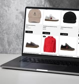 a laptop computer screen displaying YESHUA Apparel products