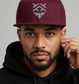 a man in a black hoodie and a maroon hat