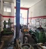 a man working on a machine in a factory