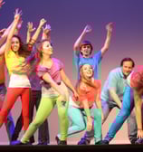 a group of parents and kids dancing on a stage