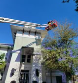 rofessional exterior high-rise painting using lift equipment by Garnet Painting & Remodeling in Douglas, GA.