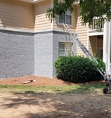 "Exterior house painting project in progress with industrial spray machine and ladder, by Garnet Painting & Remodeling in Dou