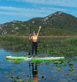 woman standing on sup on lake skadar